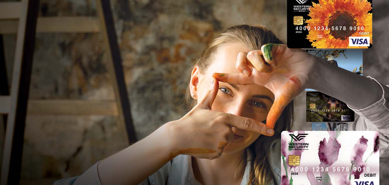 Woman with her hands in the shape of a photo portrait with various debit card images also showing.