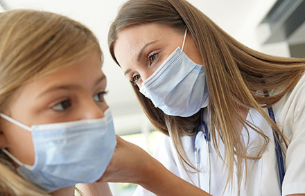 Doctor and child wearing masks